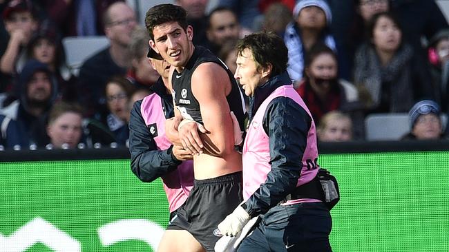 Jacob Weitering leaves the MCG with a shoulder injury.