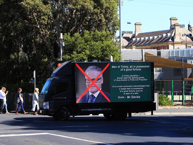 A truck with a billboard outside Trinity Grammar. Picture: Aaron Francis