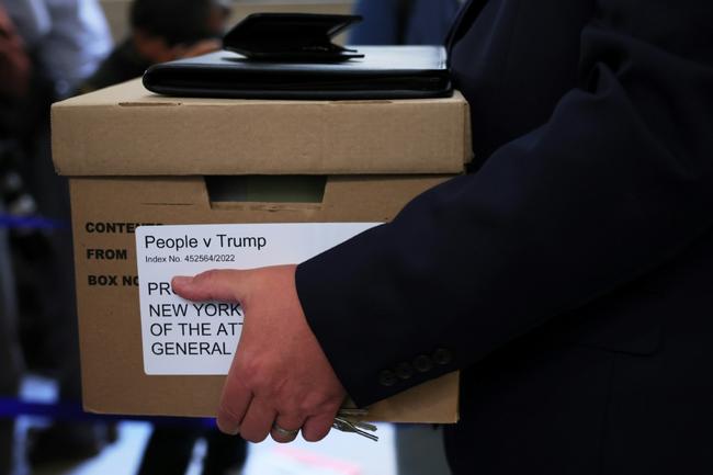 A box is carried to the opening day of the civil fraud trial against former president Donald Trump