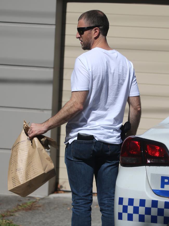 A police officer takes evidence from the home. Picture John Grainger