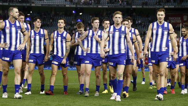 MELBOURNE, AUSTRALIA - MAY 08: North Melbourne players leave the field after a loss during the 2021 AFL Round 08 match between the North Melbourne Kangaroos and the Collingwood Magpies at Marvel Stadium on May 08, 2021 in Melbourne, Australia. (Photo by Dylan Burns/AFL Photos via Getty Images)