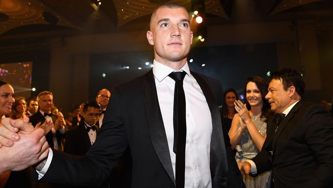 Dustin Martin walks to the stage to accept his Brownlow Medal.