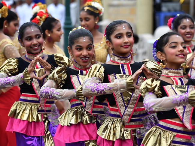 Children in traditional dress wait for Prime Minister Scott Morrison and wife Jenny to visit the Sakyamuni Sambuddha Vihara, Sri Lankan Buddhist Temple, in Berwick.