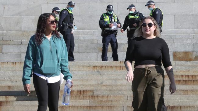 These two women received fines from police for not wearing masks at the Shrine of Remembrance on Friday. Picture: NCA NewsWire /David Crosling