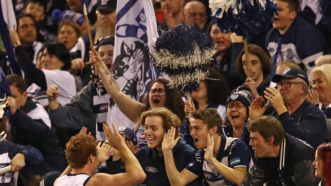 Gary Rohan embraces the Marvel Stadium crowd after booting a goal for Geelong.