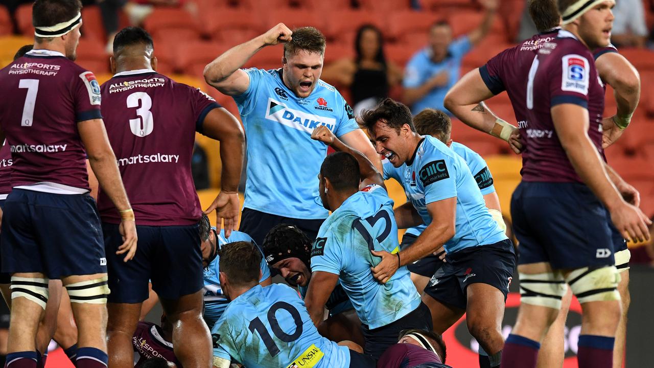 Waratahs players celebrate a try by Kurtley Beale at Suncorp Stadium in Brisbane.