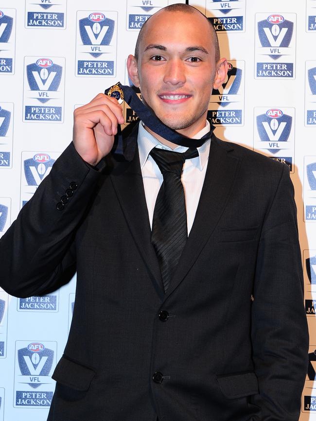 Alex Woodward with his 2014 JJ Liston Trophy.