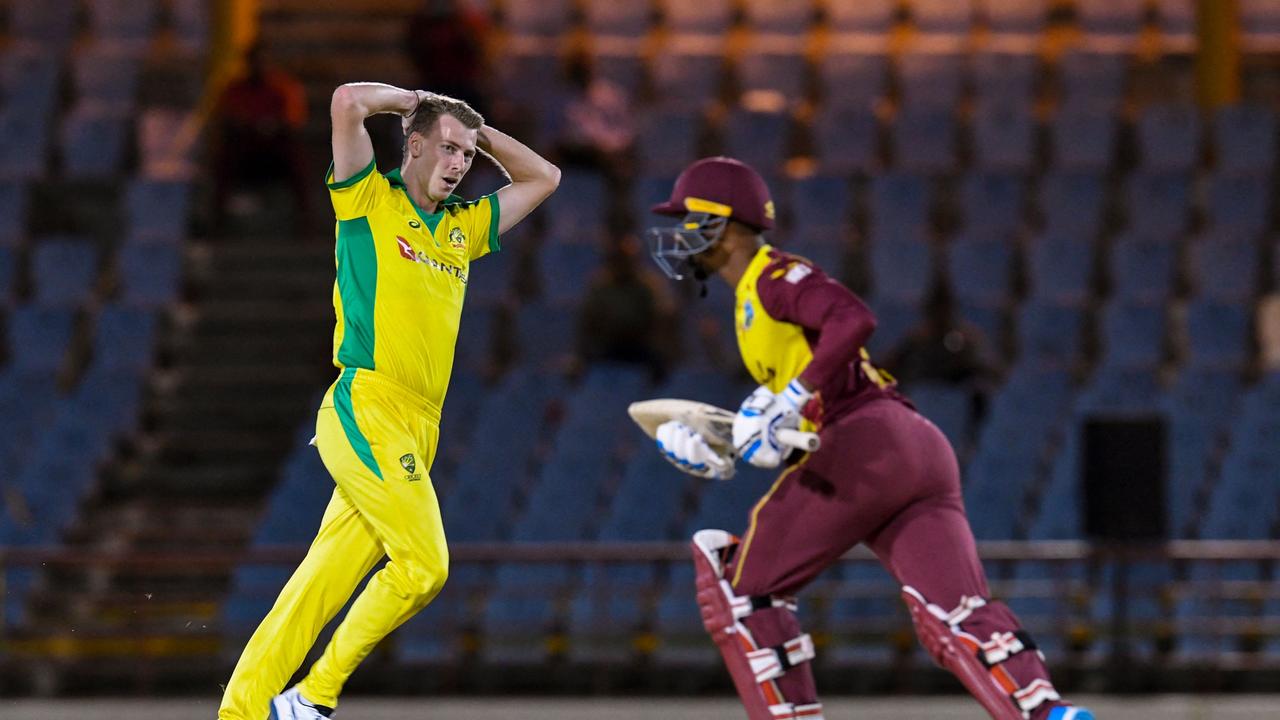 Riley Meredith (L) of Australia expresses disappointment as Nicholas Pooran (R) of West Indies runs during the 3rd T20I between Australia and West Indies at Darren Sammy Cricket Ground, Gros Islet, Saint Lucia, on July 12, 2021. (Photo by Randy Brooks / AFP)