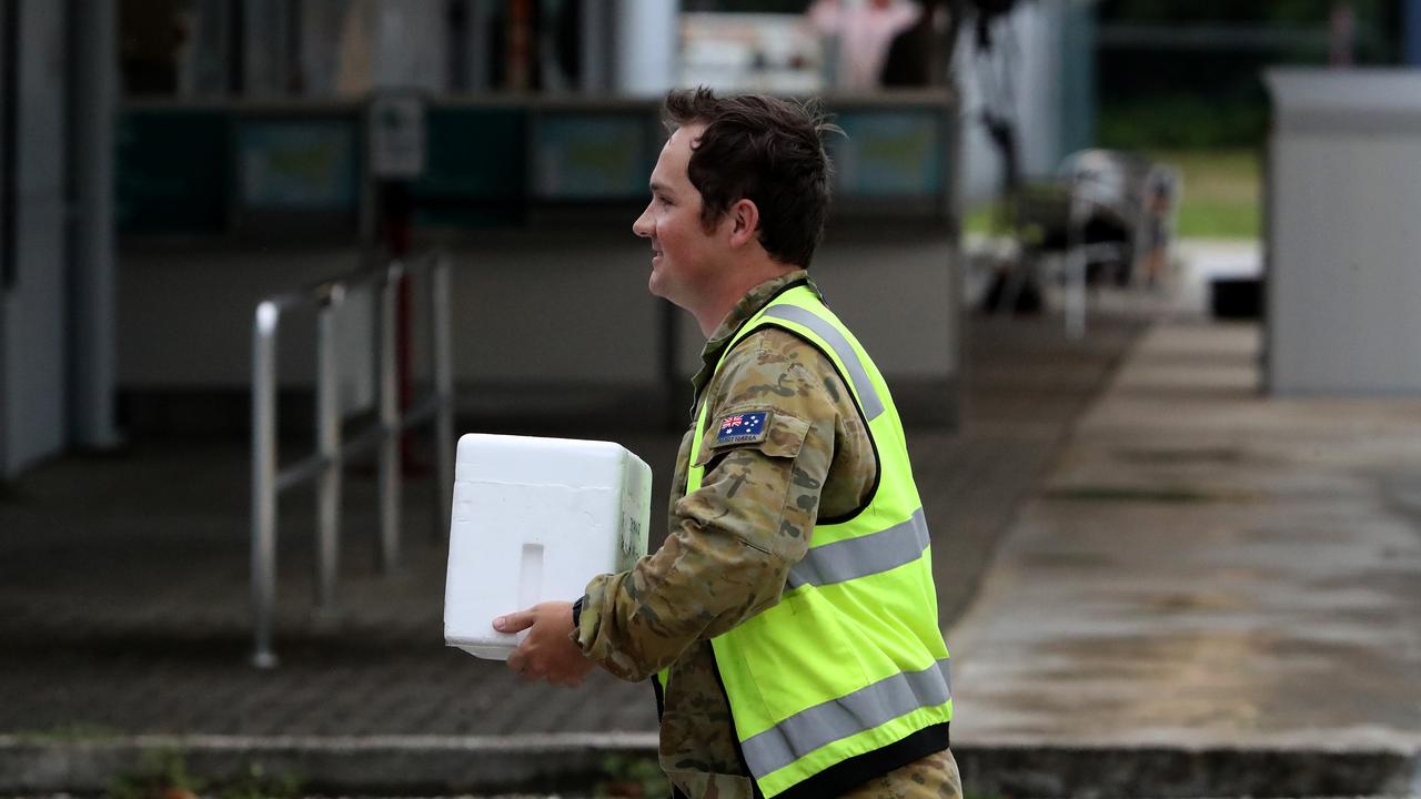 A Caronavirus test sample is taken to a waiting RAAF Hercules at Christmas Island airport. Picture: Colin Murty/The Australian