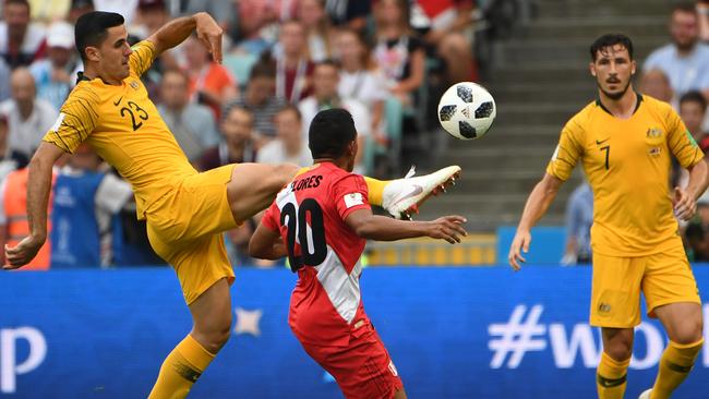 Australia's Tom Rogic comes under pressure from Edison Floresy of Peru during their final FIFA World Cup group match at Fisht Stadium during the FIFA 2018 World Cup in Sochi, Russia, Tuesday, June 26, 2018. (AAP Image/Dean Lewins) NO ARCHIVING