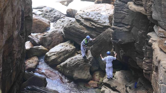 Officers had to navigate the rocky terrain in order to retrieve the body. Picture: NCA NewsWire / Max Mason-Hubers