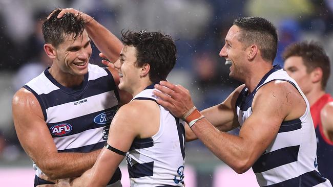 Tom Hawkins celebrates with Jordan Clark after setting up his first AFL goal in 2019. Picture: AAP Image/Julian Smith