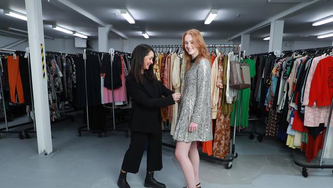 General Manager of The Turn Katie Revie helps model Sadie Wyer-Manock into an embellished silvcer coat by Italian brand Miu Miu at The Turn HQ in Punchbowl. Picture: John Feder/The Australian.