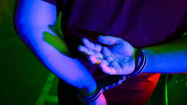 Cairns police generic handcuffs night