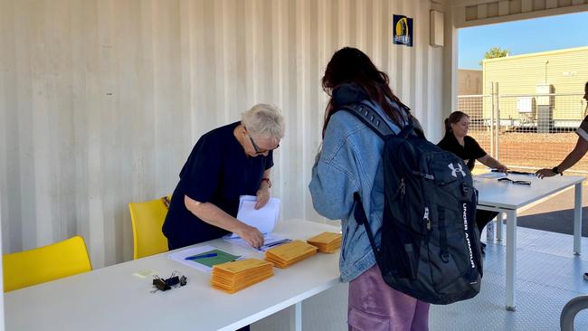 Deputy Chief Health Officer Associate Professor Di Stephens helping a woman with paperwork as she exits the Howard Springs Quarantine Facility following two weeks of isolation. Picture: Supplied/ NT Health