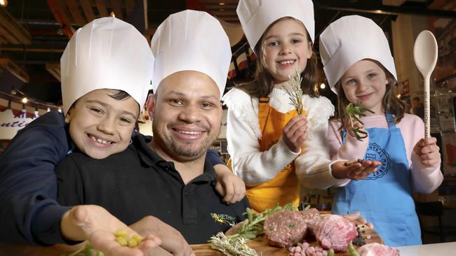 Daniel Motlop from Something Wild in the Central Market, with Marli, Ella, and Maddie, learning all about bush tucker. Picture: Dean Martin