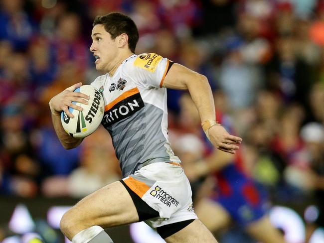 Tigers Mitch Moses makes a break during the round 10 NRL game between the Newcastle Knights and the Wests Tigers at Hunter Stadium , Newcastle .Picture Gregg Porteous