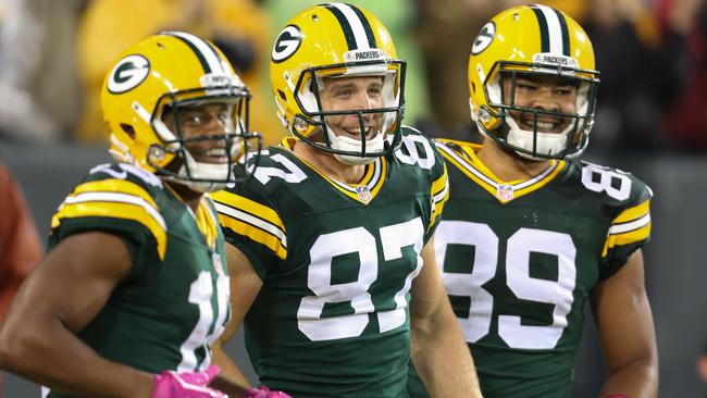 Jordy Nelson #87 of the Green Bay Packers celebrates with Randall Cobb #18 and Richard Rodgers #89 after running the football into the end zone on a 66 yard pass.