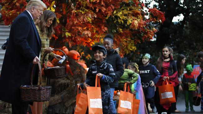 President Donald Trump and first lady Melania Trump hand out candy to kids at the White House. Picture: AP Photo/Jacquelyn Martin