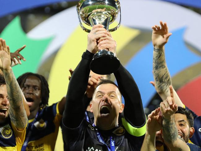 Central Coast Mariners' players celebrate with the trophy after winning the AFC Cup final football match between Lebanon's Al-Ahed and Australia's Central Coast Mariners at the Sultan Qaboos Sports Complex in Muscat on May 5, 2024. (Photo by Haitham AL-SHUKAIRI / AFP)