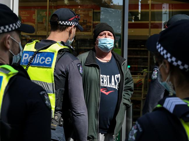 Police detain and question a man ahead of the planned protest on Thursday. Picture: Getty Images