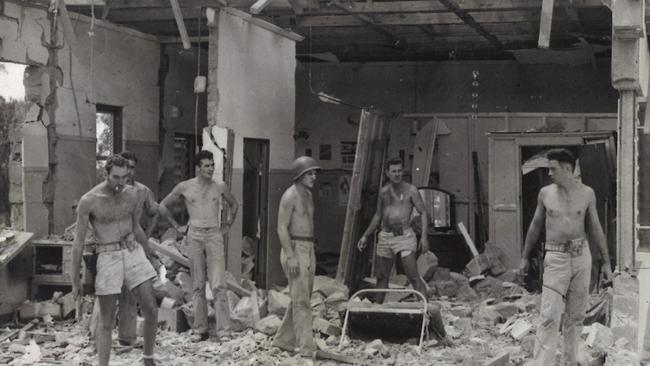 Soldiers survey damage to a Darwin house after it was hit during a Japanese bombing raid.