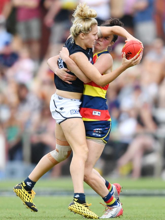 Jess Hosking of the Blues is tackled by Eloise Jones of the Adelaide Crows.