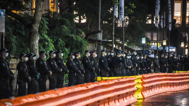 Police line up outside Town Hall ahead of the protest. Picture: Flavio Brancaleone