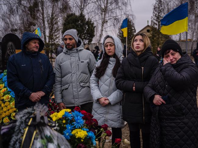 Relatives of Ukrainian serviceman Yurii Stiahliuk, killed in the Donetsk region, react next to his grave at a cemetery in Bucha, near Kyiv. Picture: AFP