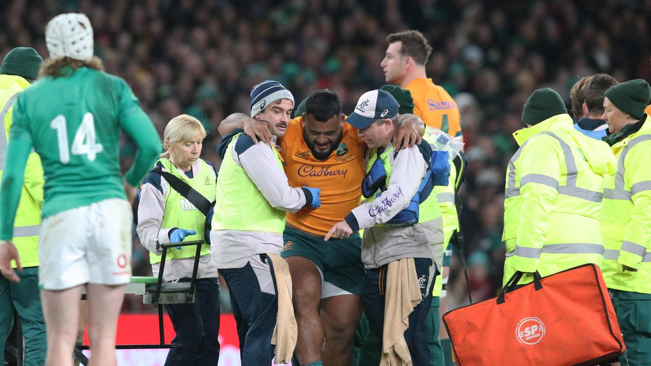 Taniela Tupou is taken off injured. (Photo by Paul Faith / AFP)