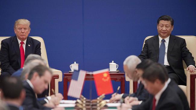 US President Donald Trump and China's President Xi Jinping attending a business leaders event inside the Great Hall of the People in Beijing.