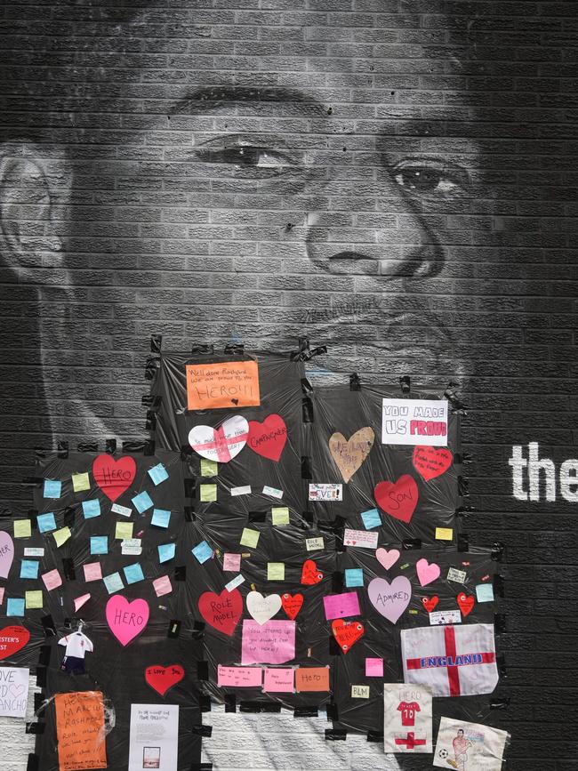 Local residents put hearts and messages of support over offensive graffiti about Marcus Rashford. Picture: AFP.