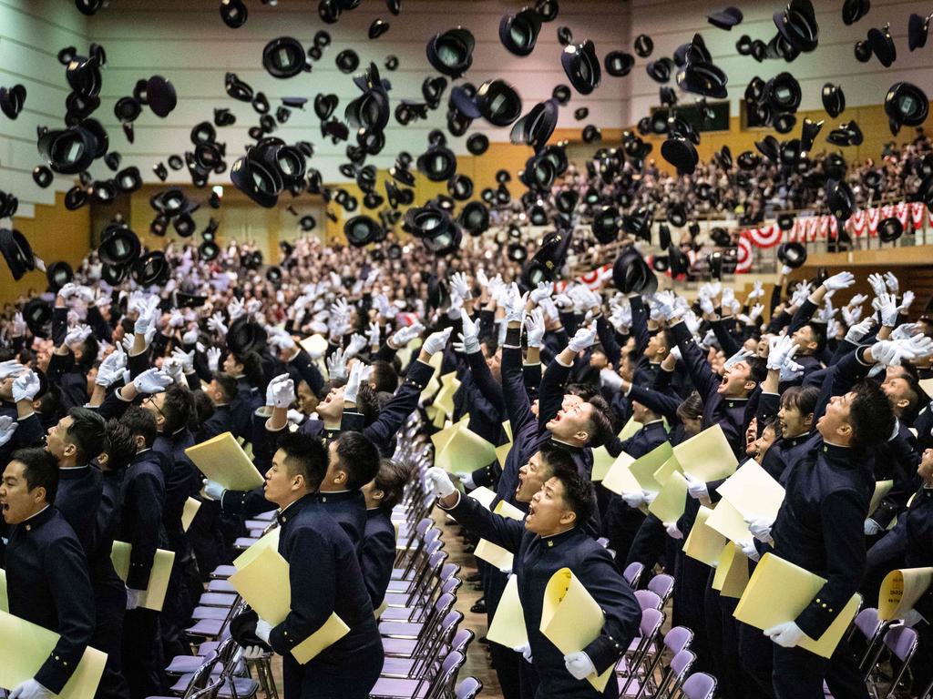 Graduates of the National Defence Academy of Japan toss their caps in the air during their graduation ceremony in Yokosuka. Picture: Yuichi Yamazaki/AFP