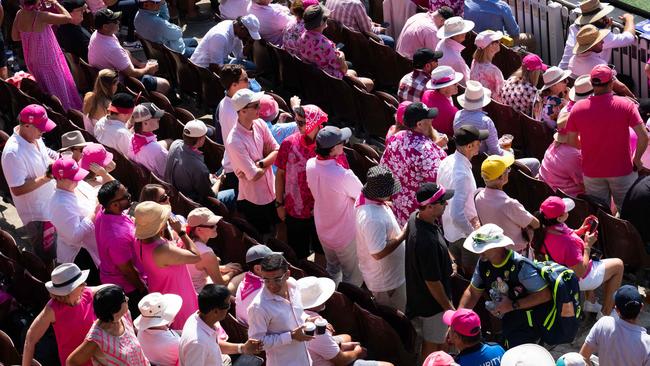 The Sydney test turns pink as Jane McGrath Day takes full swing. Volunteers unveil the silk in front of the members stand at the start of day 3 of the 5th Test Photo: Tom Parrish