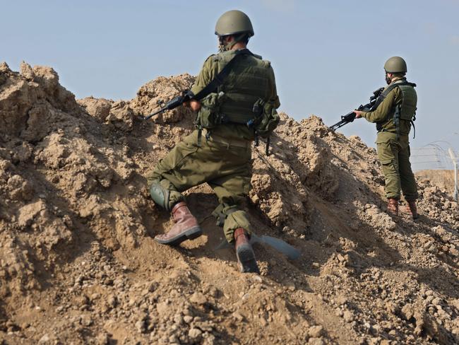 Israeli soldiers take a defensive position in Kibbutz Be’eri along the border with the Gaza Strip. Picture: AFP