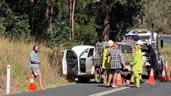 The scene of a truck and car crash on the Mary Valley Highway, where three people are being assessed by paramedics.