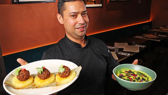 Chef from Sacred Bites restaurant in New Town, Deepak Koirala with some of the restaurants Indian dishes. Picture: Zak Simmonds