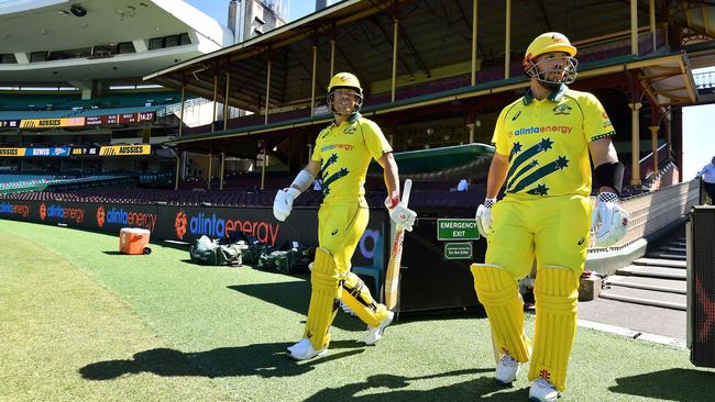 Australia's Aaron Finch (R) and David Warner walk into an empty SCG in March. (Photo by Saeed KHAN / AFP) / -- IMAGE RESTRICTED TO EDITORIAL USE - STRICTLY NO COMMERCIAL USE --