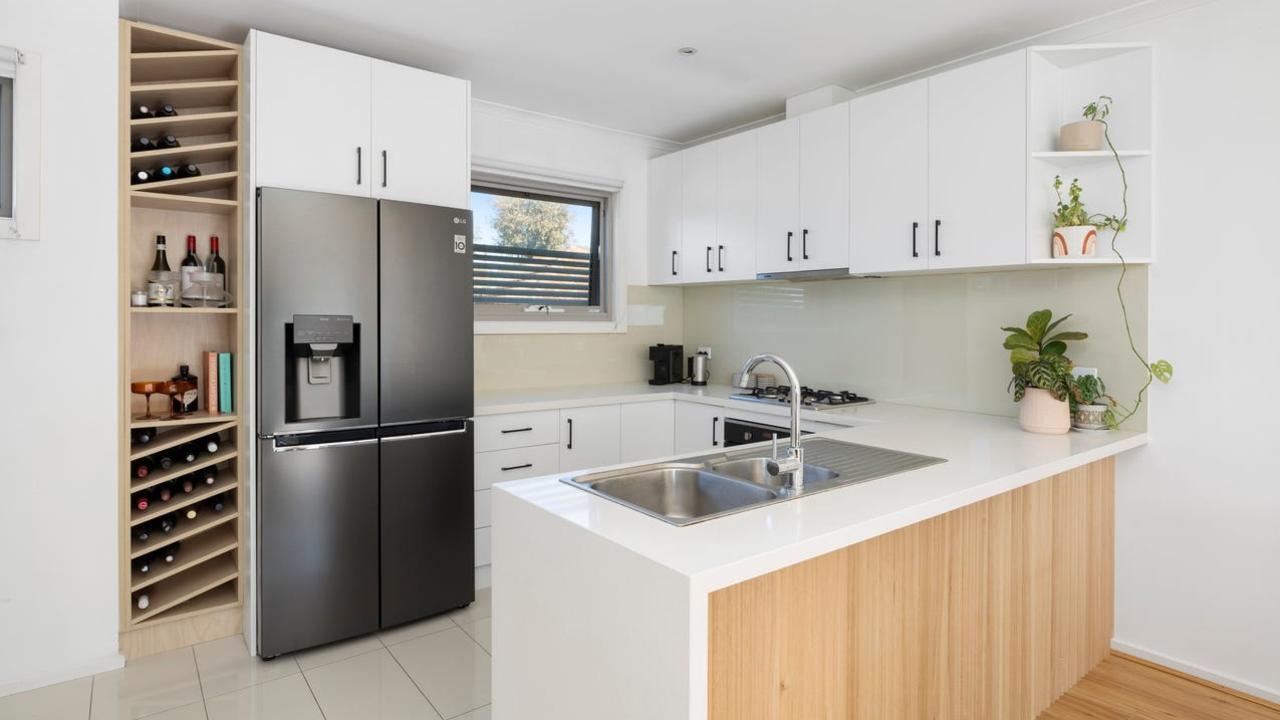 The kitchen is fitted with stone benchtops, a walk-in pantry and Blanco appliances, plus a breakfast bar.