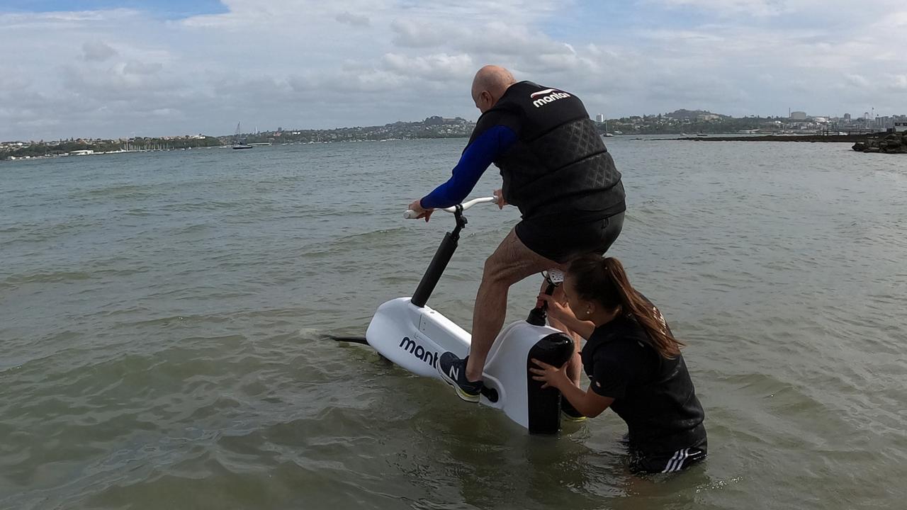 Chris Griffith is helped by instructor Stacey Kitchen to get the Hydrofoiler XE-1 by Manta5 up and running at Devonport beach in Auckland.