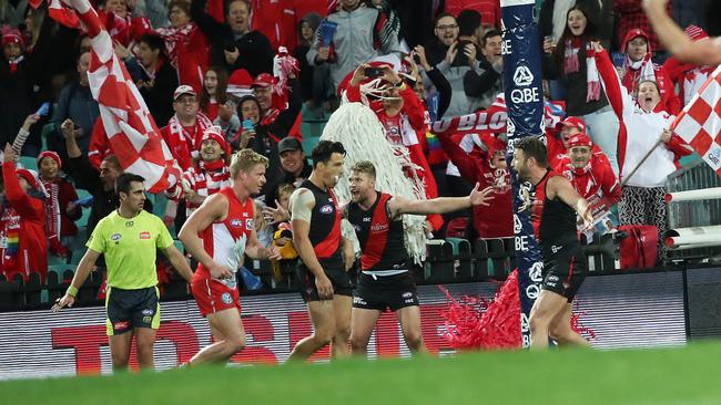 Jake Stringer and Cale Hooker appeal for a free kick after Rampe climbed the goalpost. Picture: Phil Hillyard