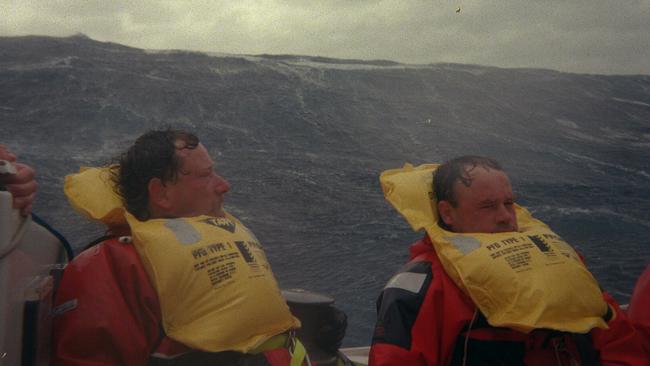 Crew members onboard Stand Aside during the violent condition of the 1998 race. Picture: ROD HUNTER