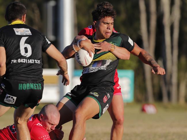 Campbell Pirihi of Helensvale Hornets is tackled by Luc Lyndon and Tahne Robinson of Currumbin Eagles during the Rugby League Gold Coast A Grade clash. Photo: Regi Varghese