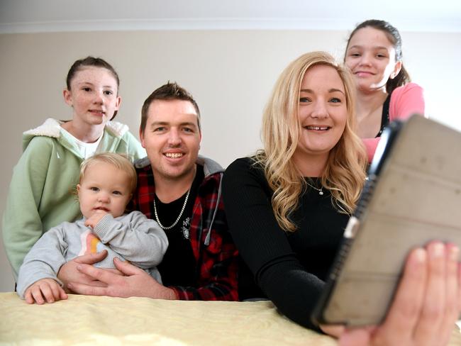 Kristian Hancox and Tracey Slone with kids Izabelle Hancox age 11, Kaydence Hancox-Slone age 2  and Aaliyah Slone age 12 are using the Heritage bank's budget planner at home in Capalaba.Saturday May 23, 2020. (Picture, John Gass)