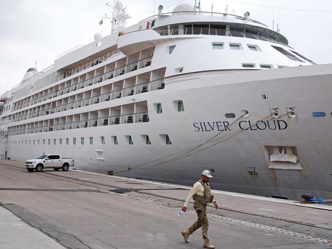 A federal police officer walks past the the Silver Cloud cruise ship.