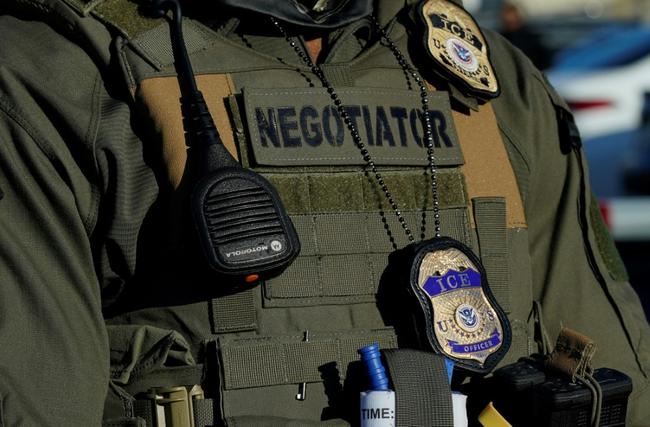This file photo shows an Immigration and Customs Enforcement (ICE) agent standing near a newly converted immigrant detention centre in New Jersey in May