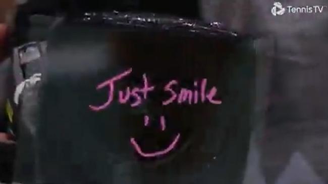 Alex de Minaur's written message on the TV camera. Photo: Tennis TV.