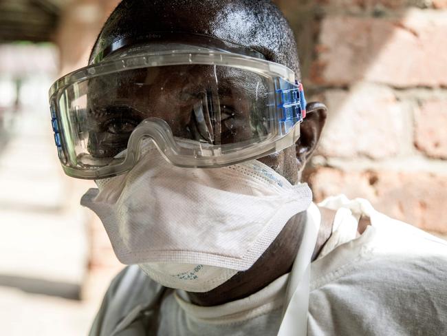 In this handout photograph released by UNICEF on May 13, 2018, a health worker wears protective equipment as he looks on at Bikoro Hospital - the epicenter of the latest Ebola outbreak in the Democratic Republic of Congo -  on May 12, 2018, which has sealed off a ward to diagnose suspected Ebola patients and provide treatment.   The outbreak in the region northeast of Kinshasa near the border with the Republic of Congo has so far killed 18 people around the town of Bikoro in Equateur province, according to the WHO. A report from the provincial council of ministers, seen by AFP, said there were "three suspected cases" in the region's capital Mbandaka, which has 700,000 inhabitants.  / AFP PHOTO / UNICEF / MARK NAFTALIN / RESTRICTED TO EDITORIAL USE - MANDATORY CREDIT "AFP PHOTO /UNICEF/MARK NAFTALIN" - NO MARKETING NO ADVERTISING CAMPAIGNS - DISTRIBUTED AS A SERVICE TO CLIENTS