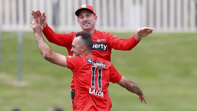 Renegades Josh Lalor celebrates with Shaun Marsh after taking a wicket.