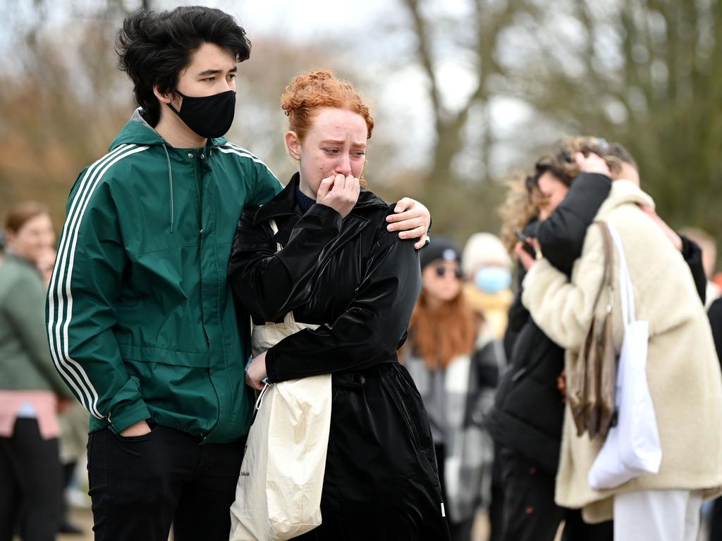 Members of the public react as they stand before tributes for Sarah Everard at the bandstand on Clapham Common. Picture: Getty Images